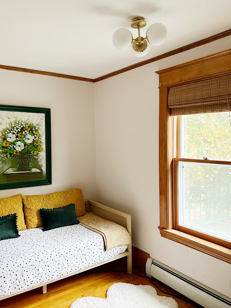 Overflow guest room with bamboo blinds. Green and yellow accents
