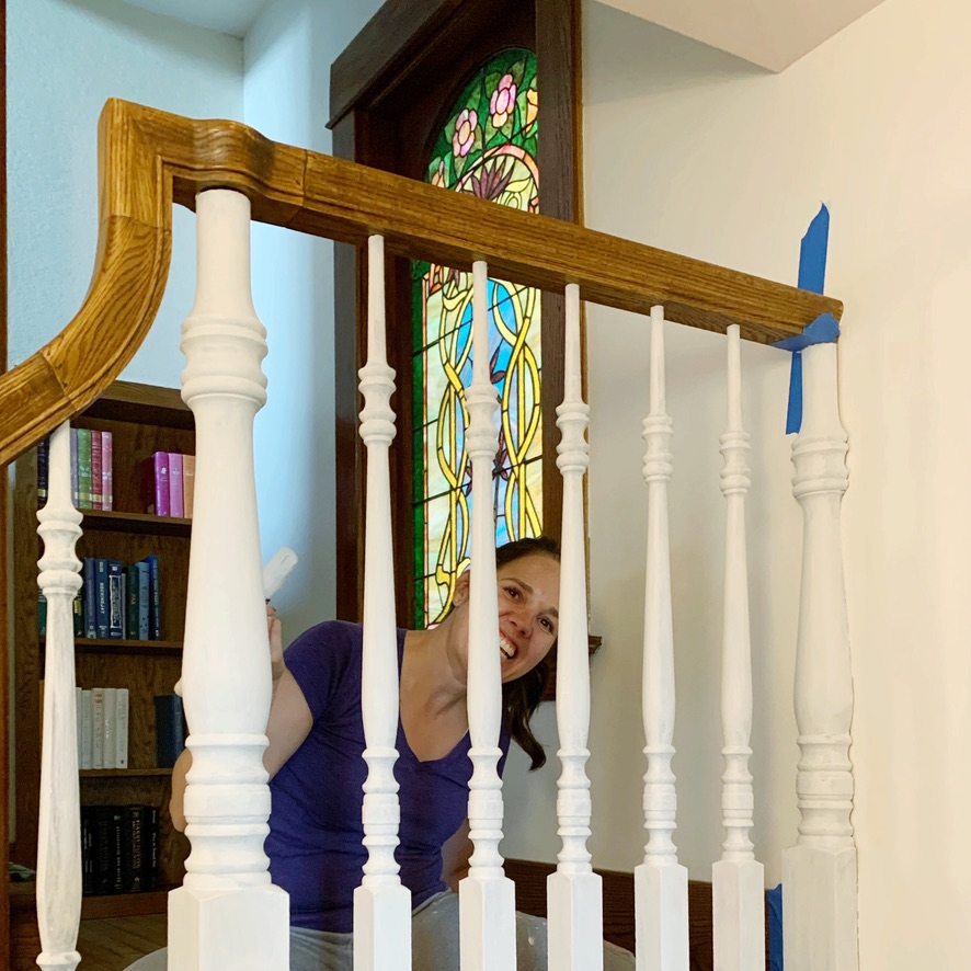 painting the banister rails during the stair makeover