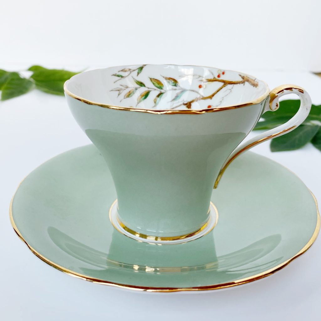 green teacup with gold trim 