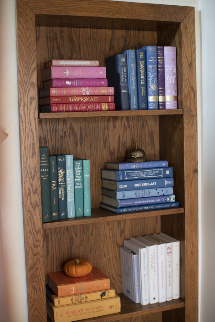 Bookshelf with books arranged by color